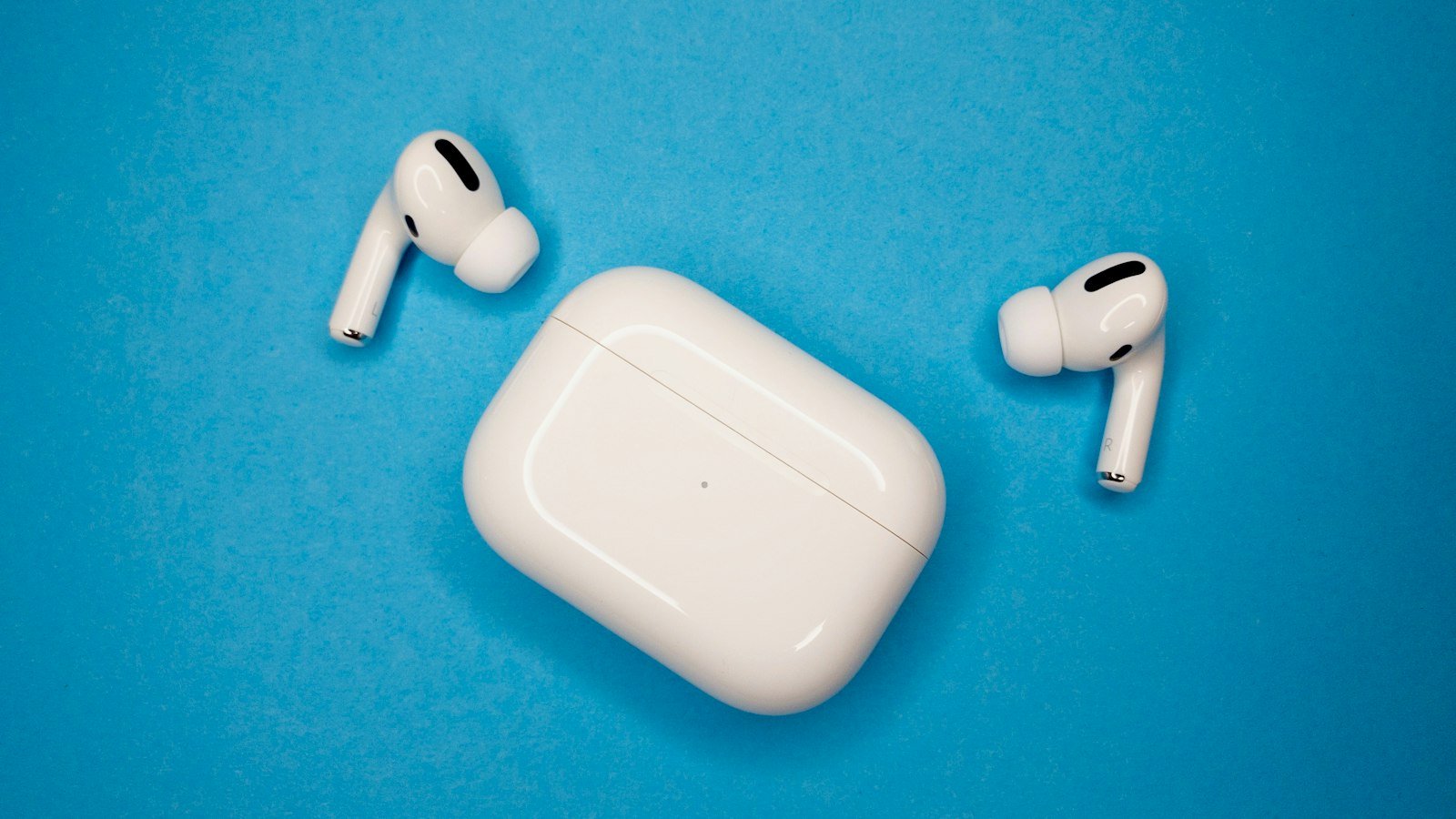 White wireless earbuds in an open charging case