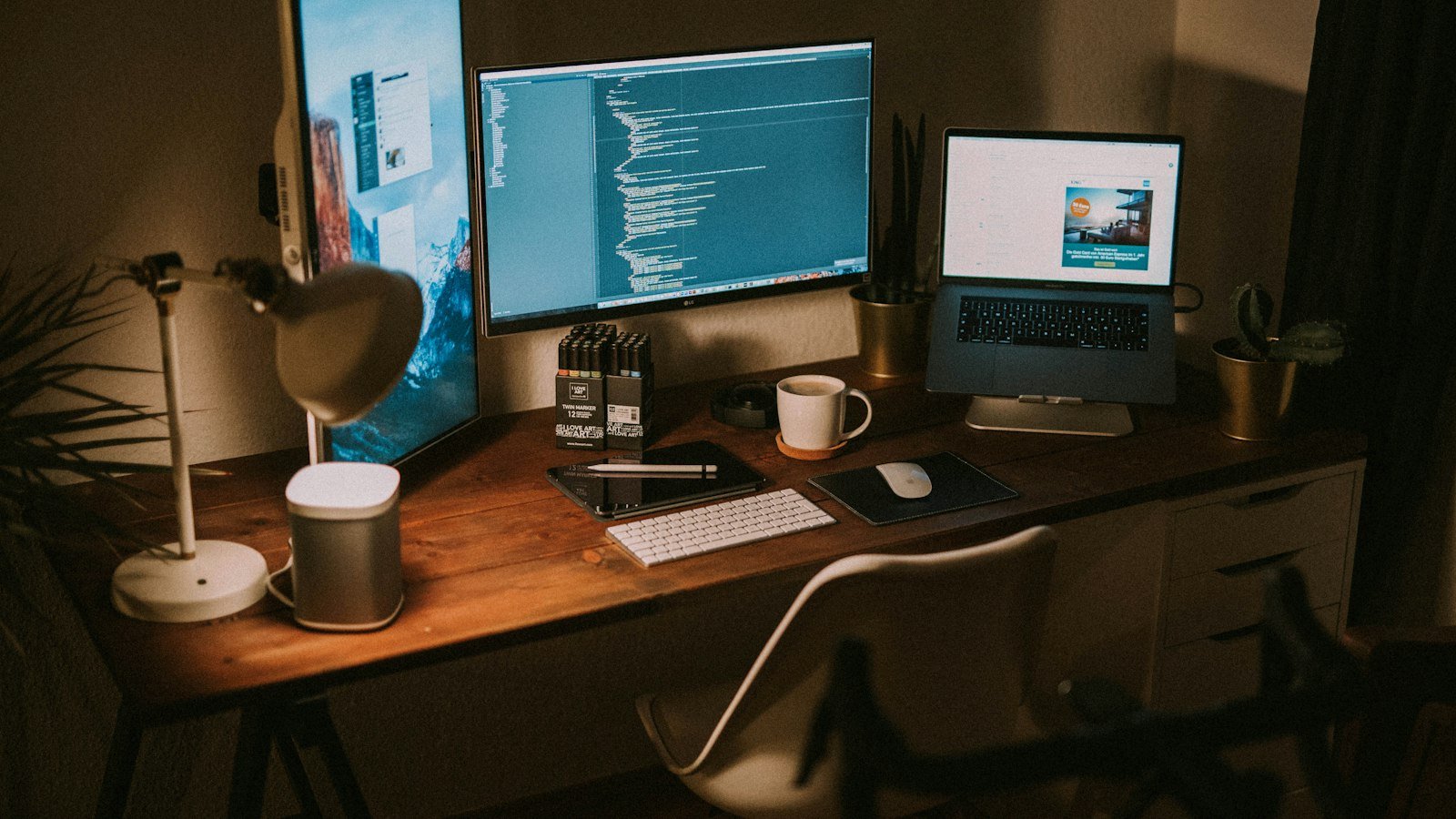Two monitors and a MacBook Pro on a developer desk setup