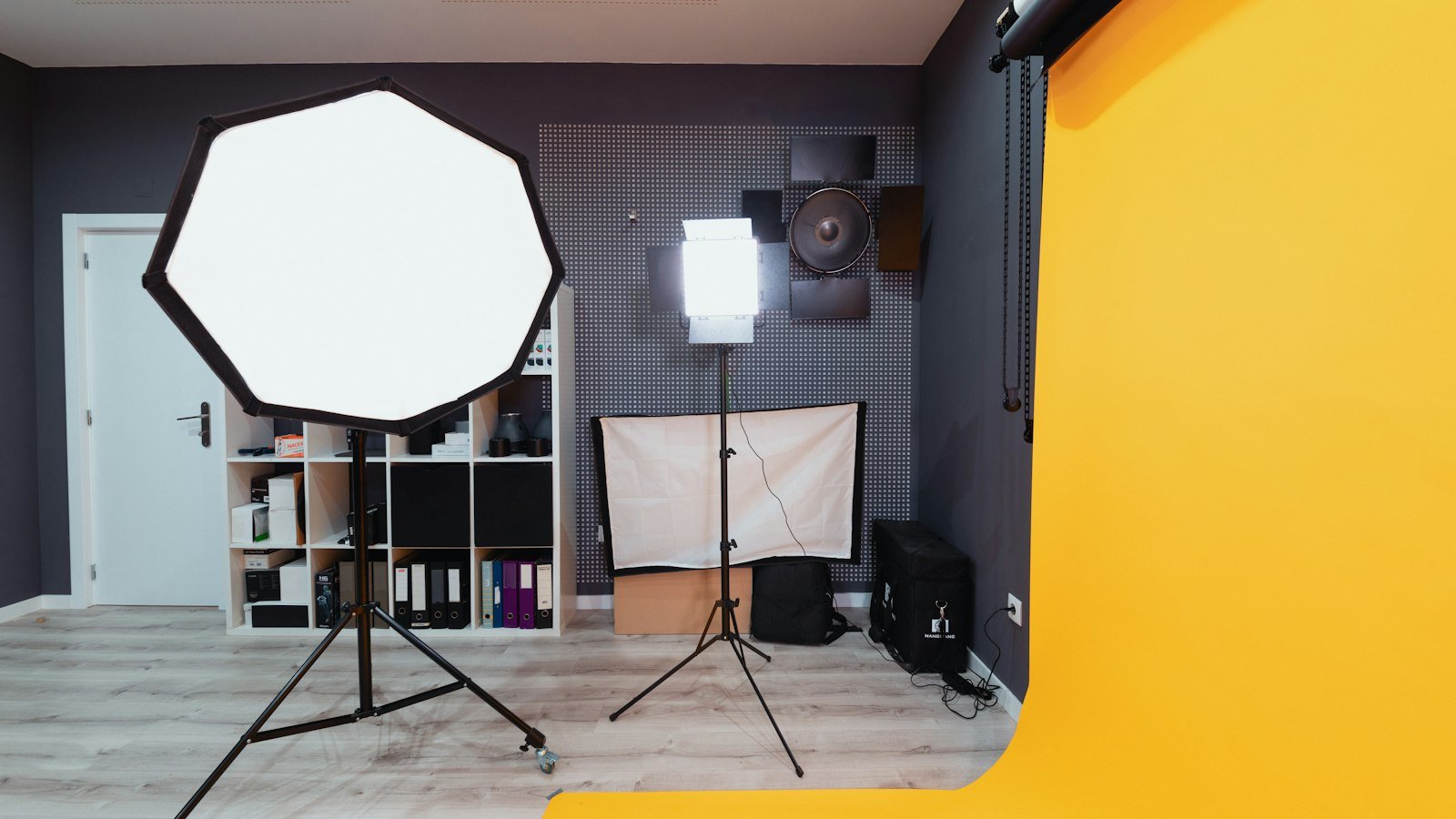 Home video studio with a studio light and a camera tripod
